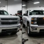 Two identical pickup trucks parked next to each other, one featuring a boring factory grille and the other featuring an aggressive aftermarket matte black grille with amber LED lights.